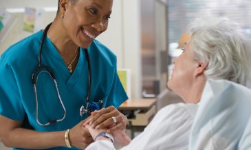 A nurse comforting a patient