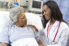 Female doctor comforting female patient